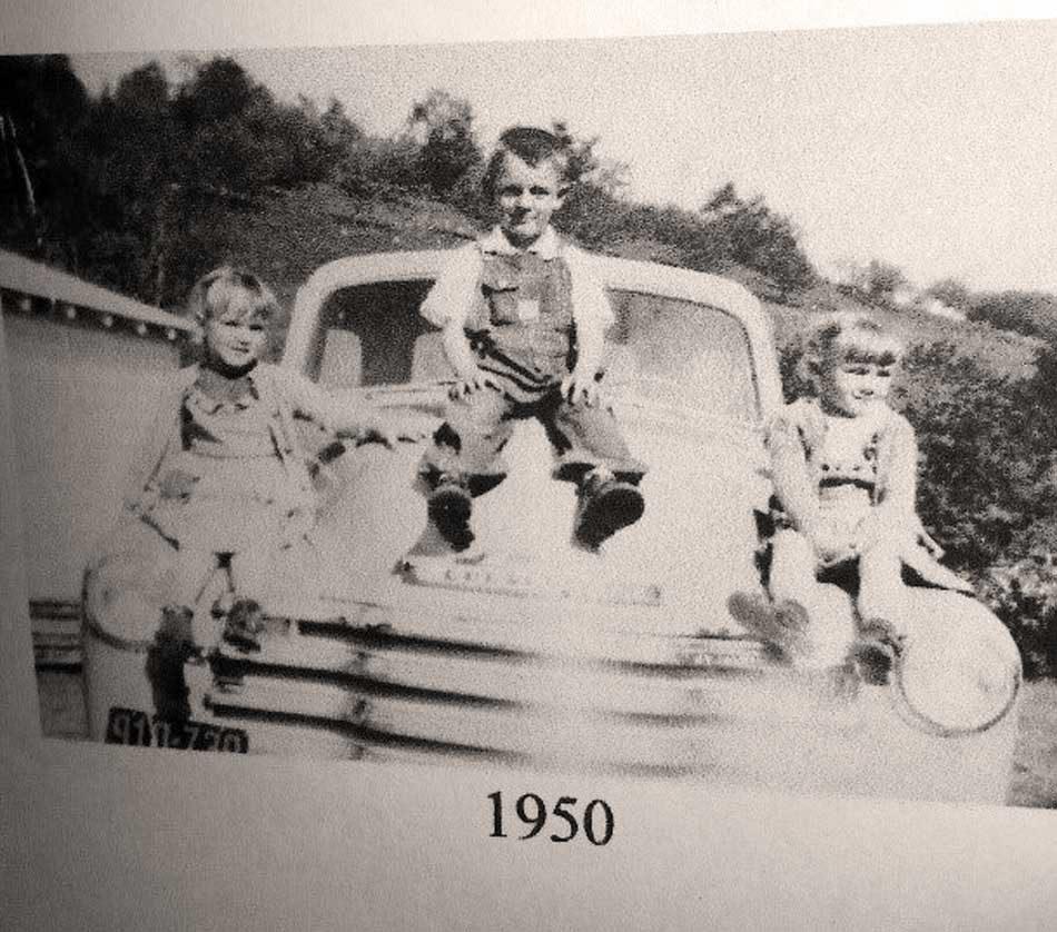 Bea Wellborn, Benny Wellborn, Betsy Wellborn, siblings aged 3, 5 and 4. Photo made by Joann Elizabeth Wellborn Norris Underwood at her father, Joe Wellborn's, house in Stony Fork, Watauga, with Joann's new Brownie camera given to her by her sister, Marie. Photo courtesy of Beatrice Wellborn, Stony Fork Community.