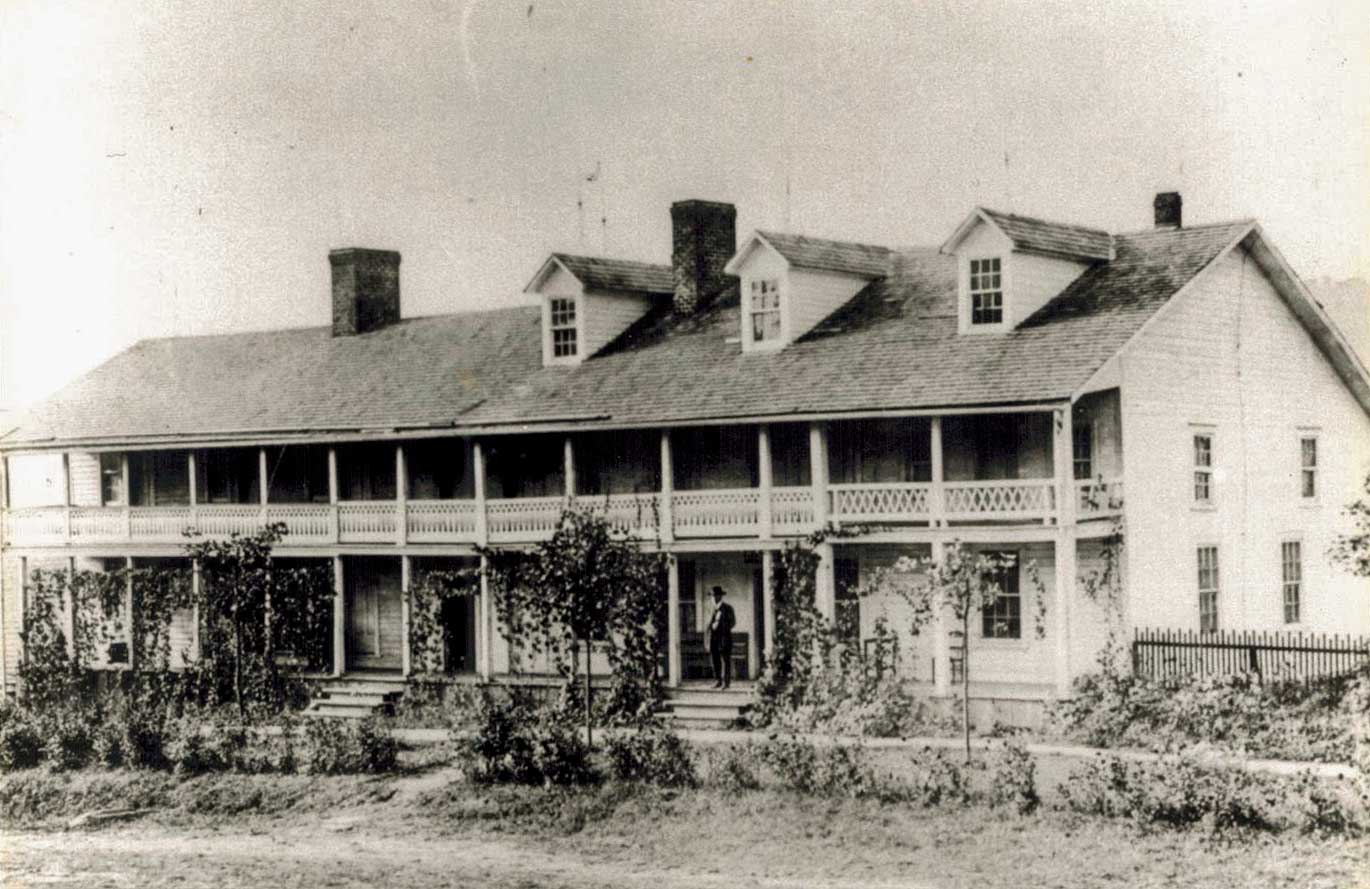 The Blair Hotel stood at the intersection of King Street and Depot Street. The property went down to Rivers Street. The Barn and cattle pasture was between Rivers Street and (Kraut Creek) Boone Creek. The garden was between Boone Creek and the hotel. William Thomas Blair, owner, is standing on the porch, ca.  1910. Photo courtesy of Steve Sudderth.